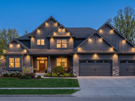 Home with warm white permanent eave lighting at dusk
