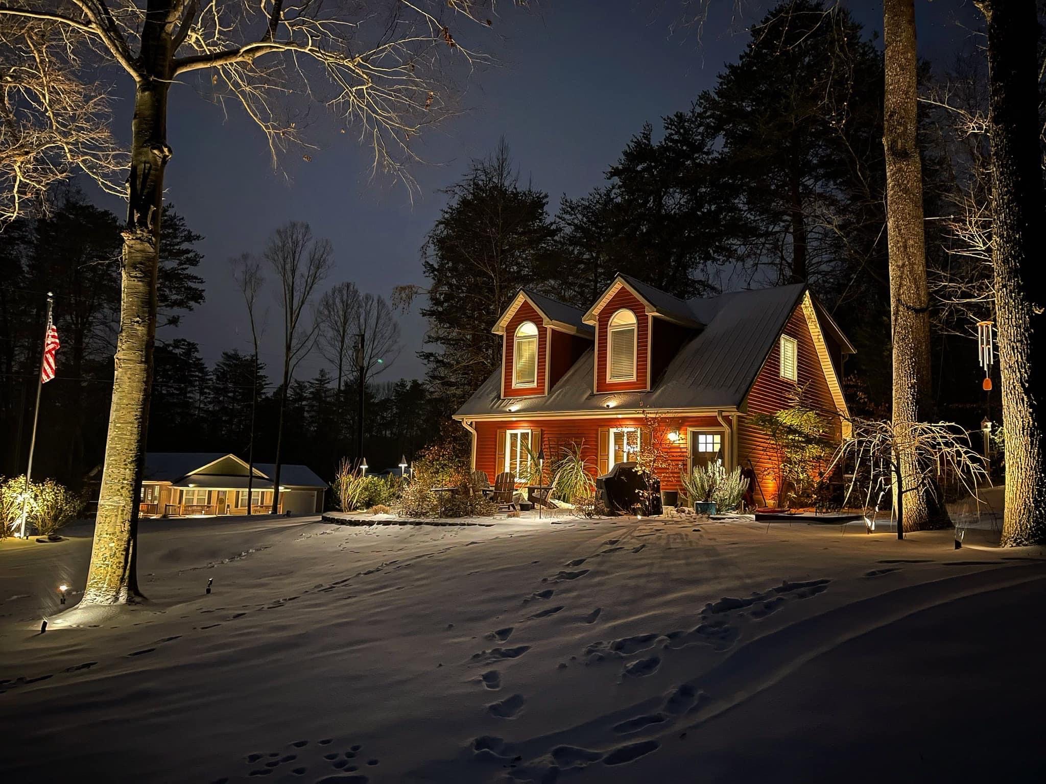 Low-voltage landscape lighting on a home and yard at night
