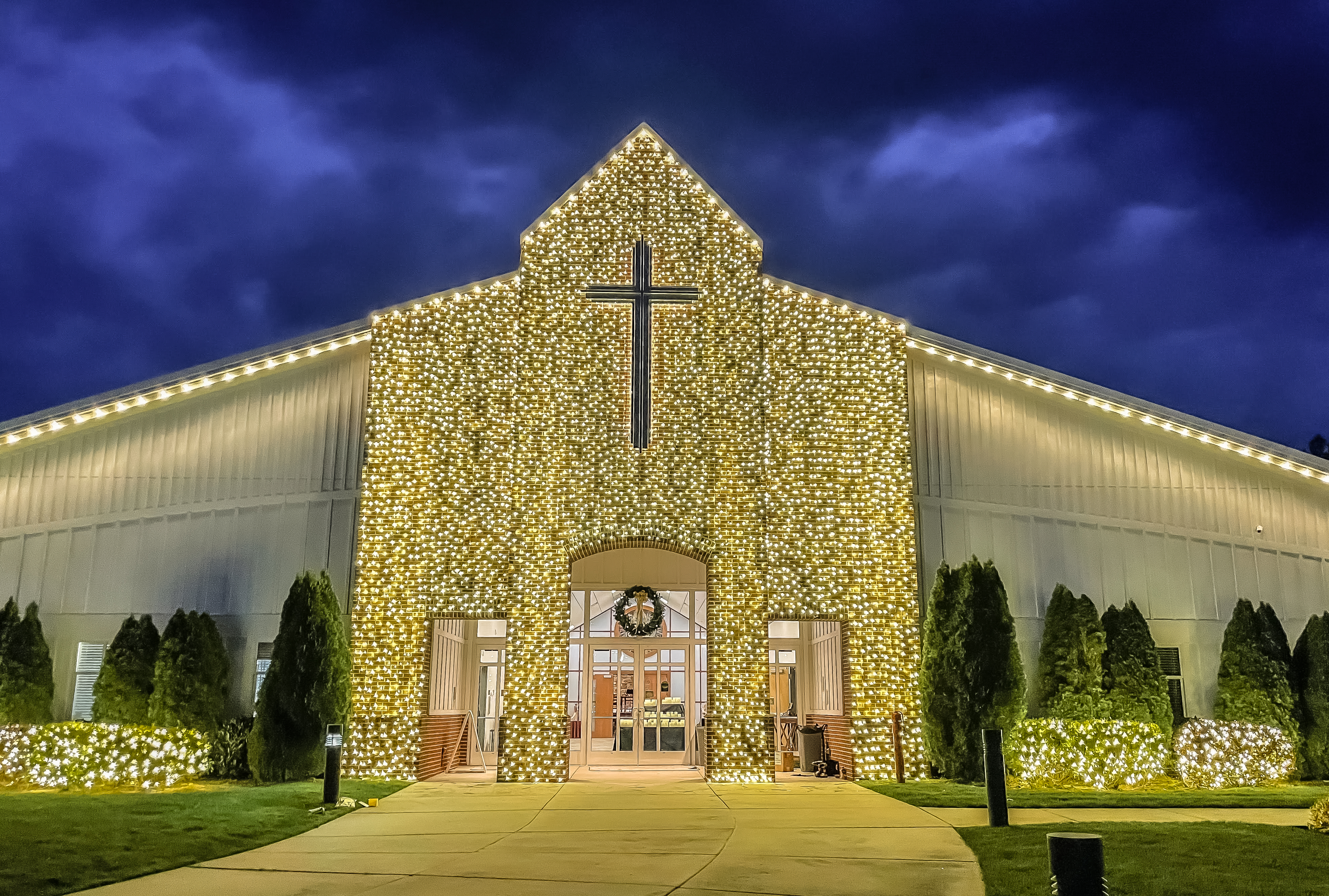 Commercial building decorated with holiday lighting at night