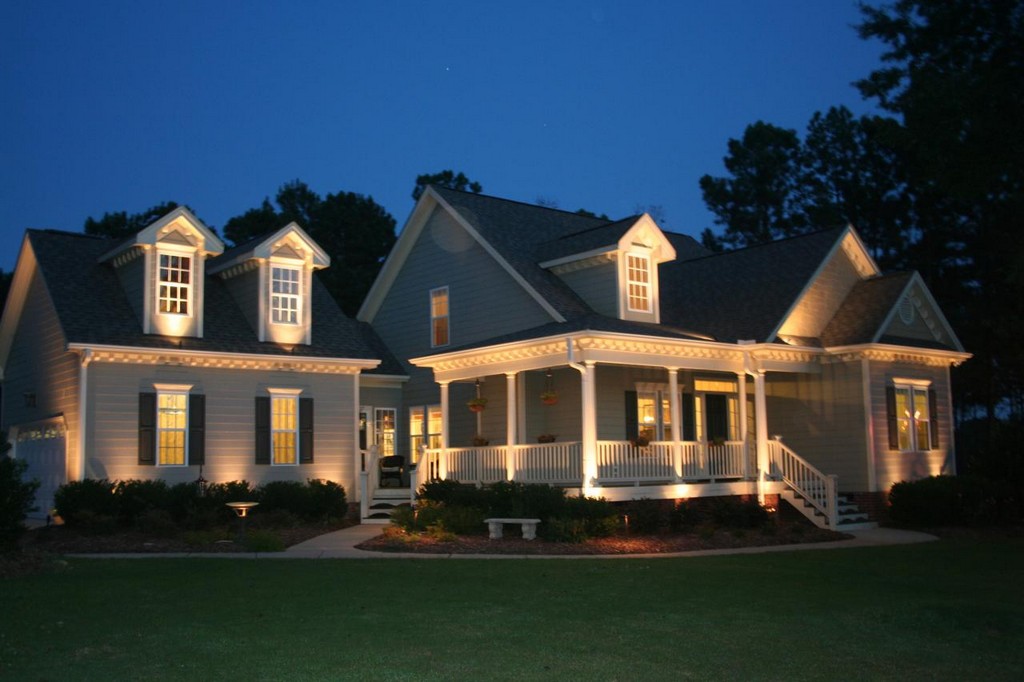 Farmhouse porch and garden with landscape lighting