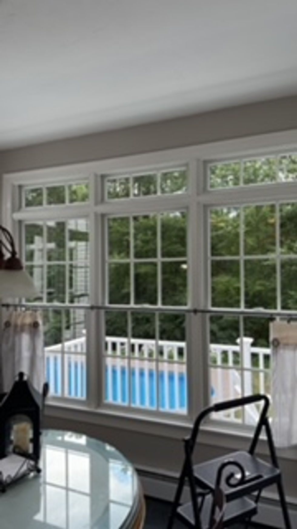 Sunroom windows overlooking a pool