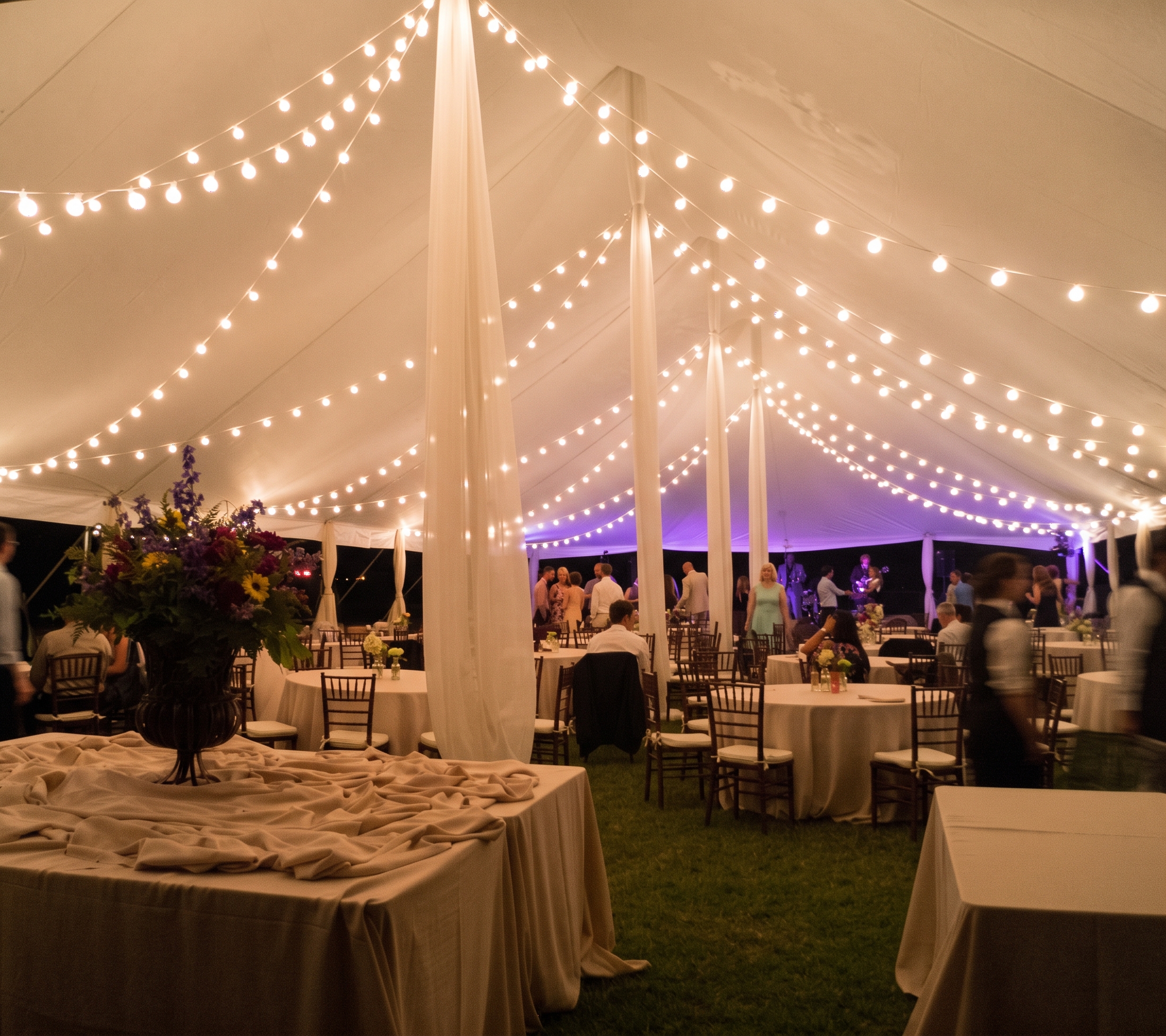 Wedding reception tent with draped string lighting