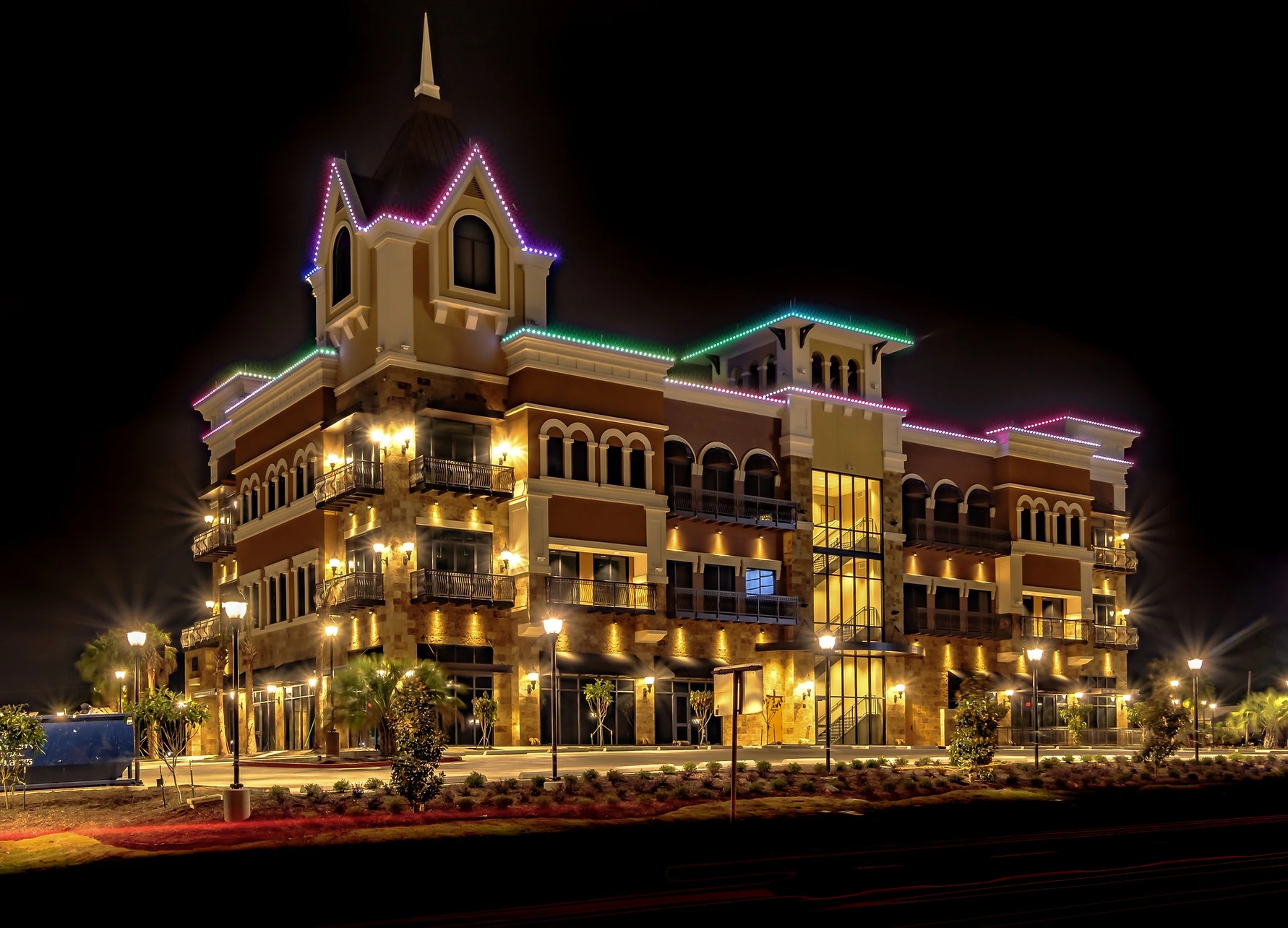 Commercial building decorated with holiday lighting at night