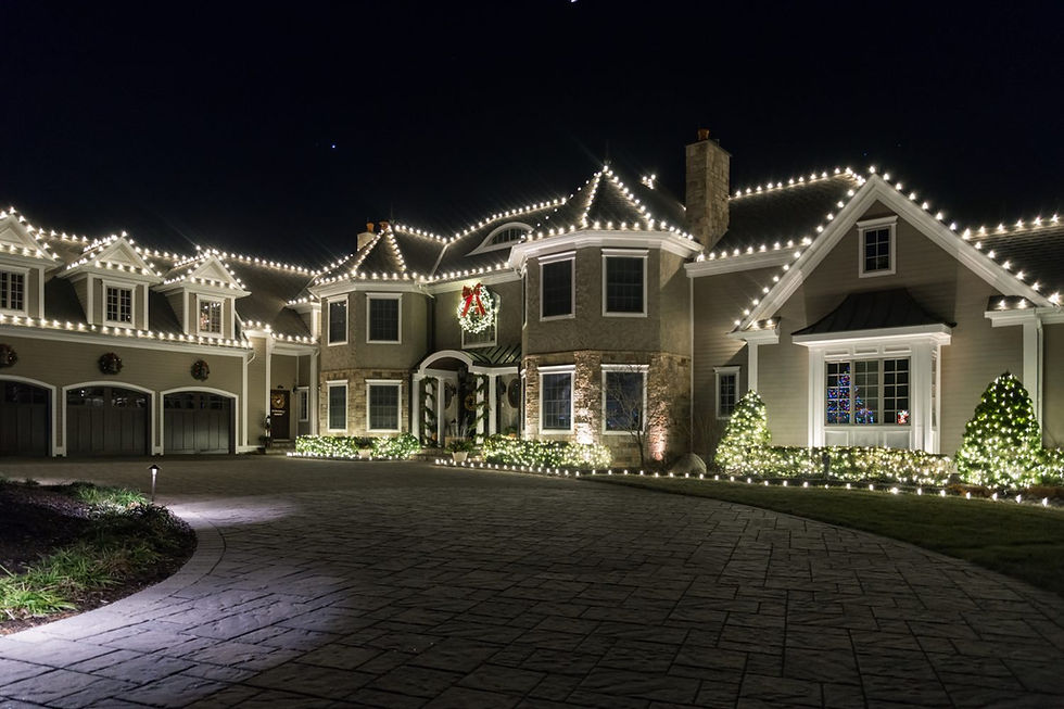 Professionally installed Christmas lights on a home roofline at night
