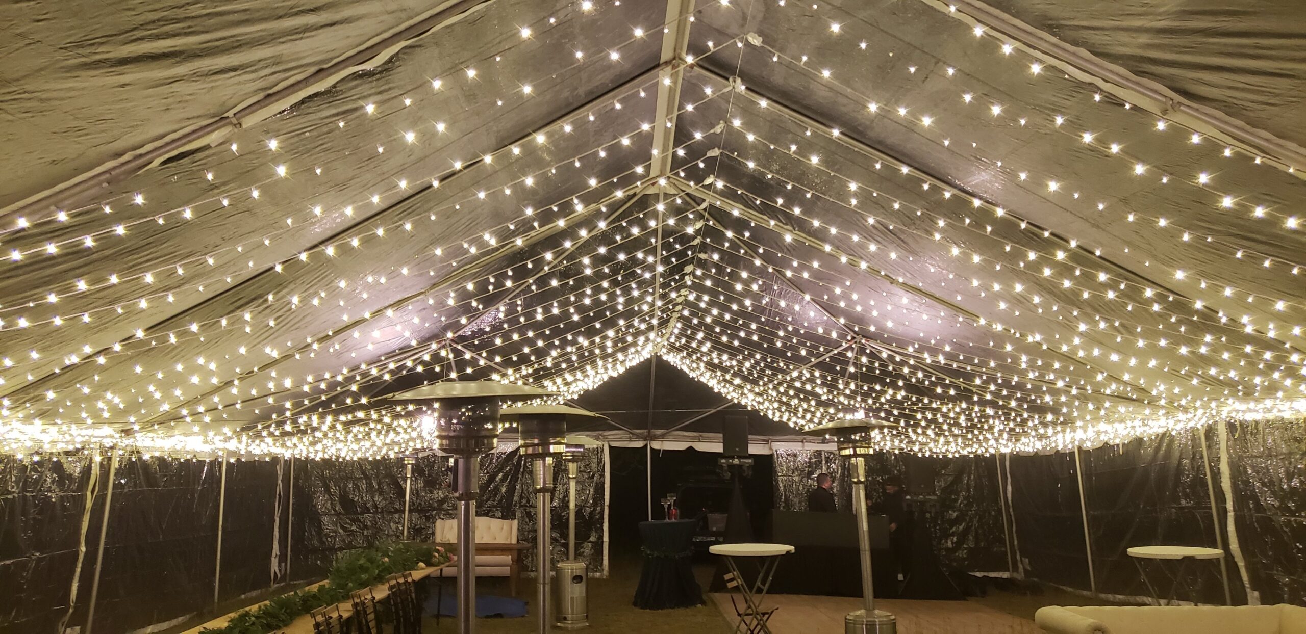 Wedding tent canopy filled with string lights