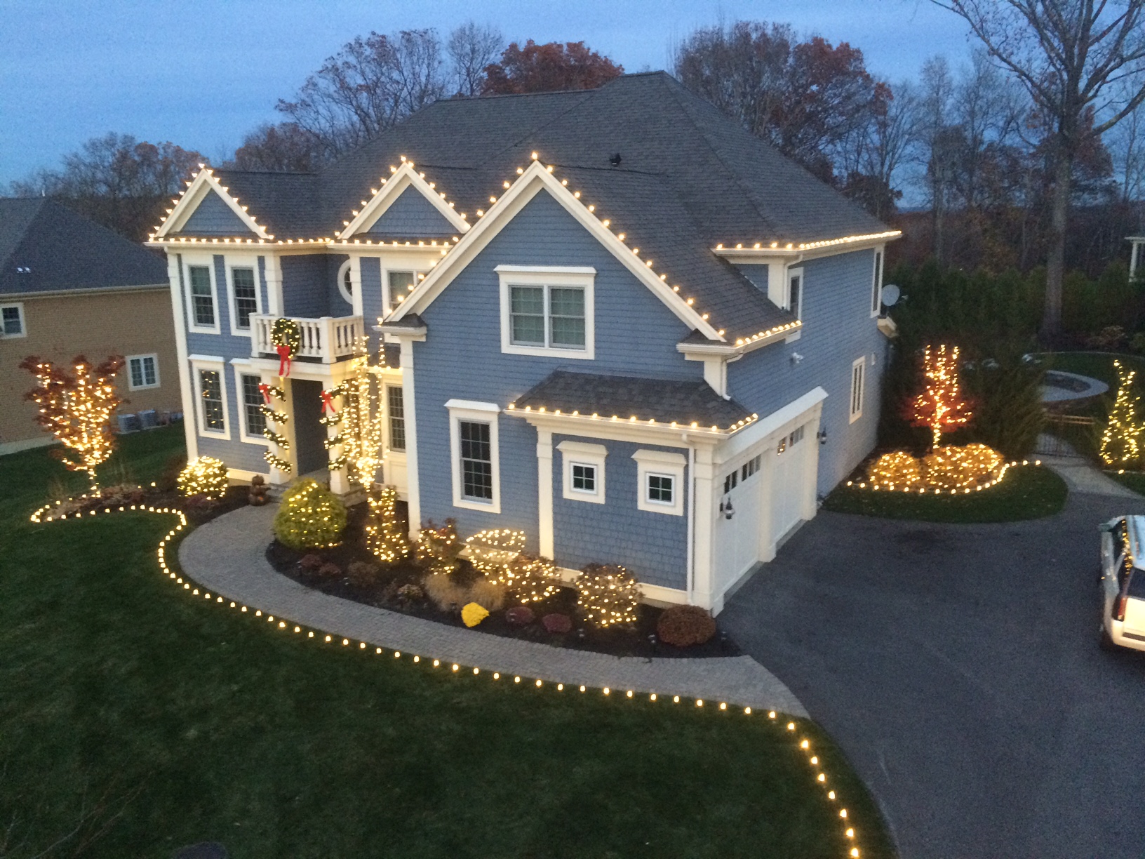 Low-voltage landscape lighting on a home and yard at night