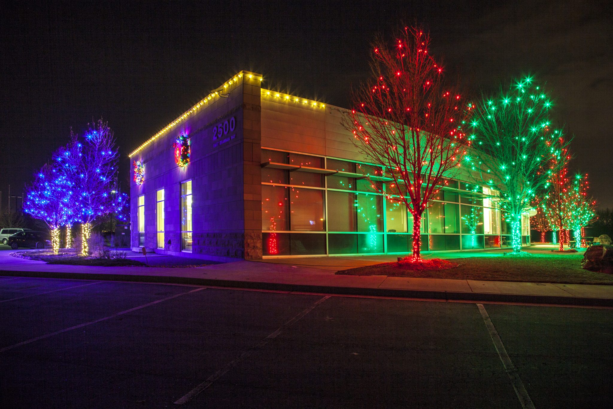 Commercial building decorated with holiday lighting at night
