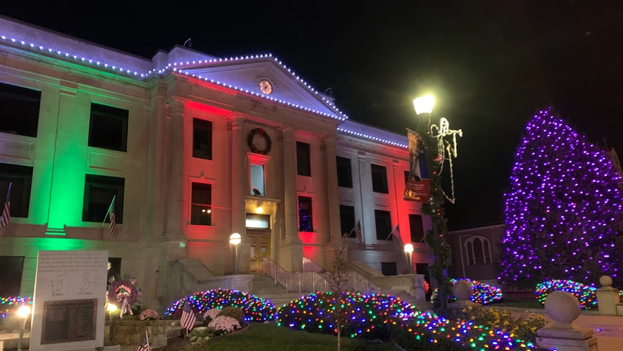 Commercial building decorated with holiday lighting at night