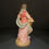 Thumbnail: Woman holding a basket of flowers figurine rear view