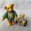Thumbnail: bear in green sweater pulling cub figurine front view