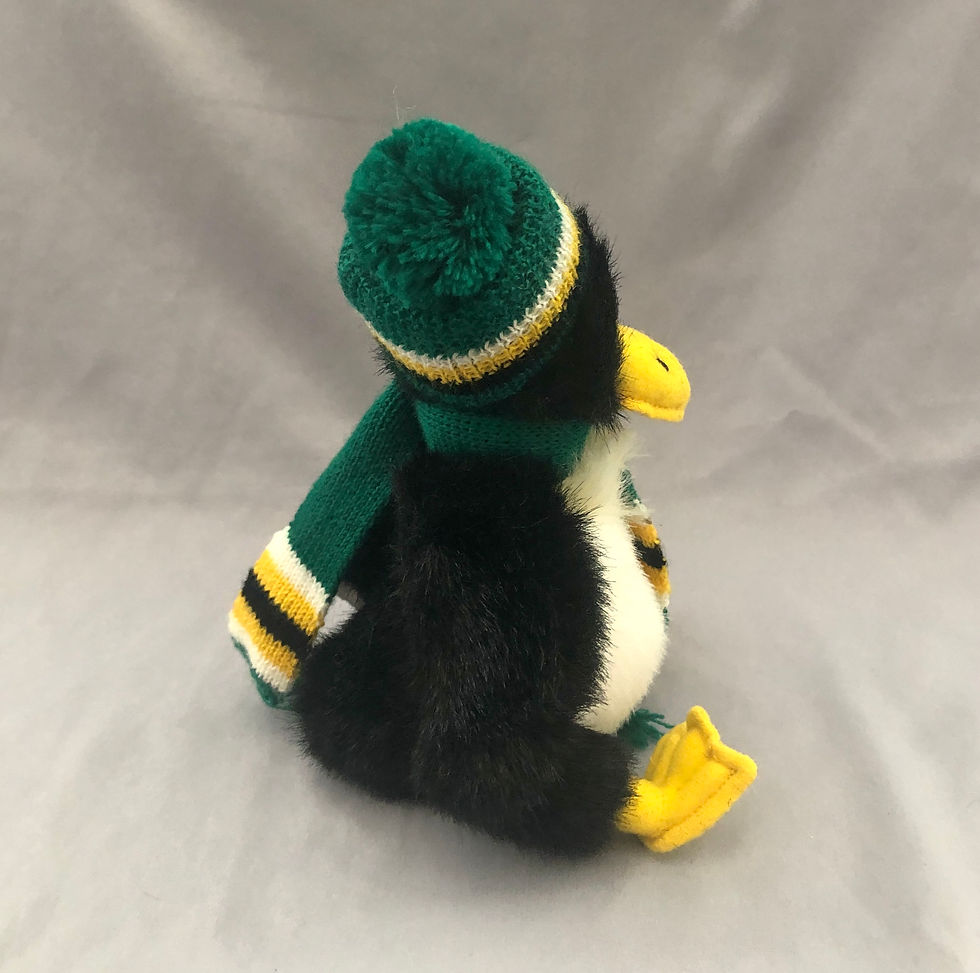 Thumbnail: Stuffed animal penguin with hat and scarf side view