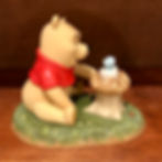 Winnie the pooh looking a bird figurine back view