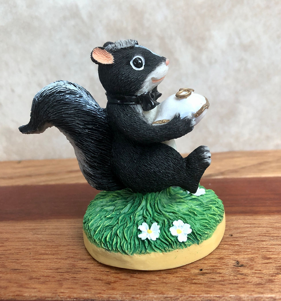 Thumbnail: charming tails The Ring Bearer skunk figurine side view
