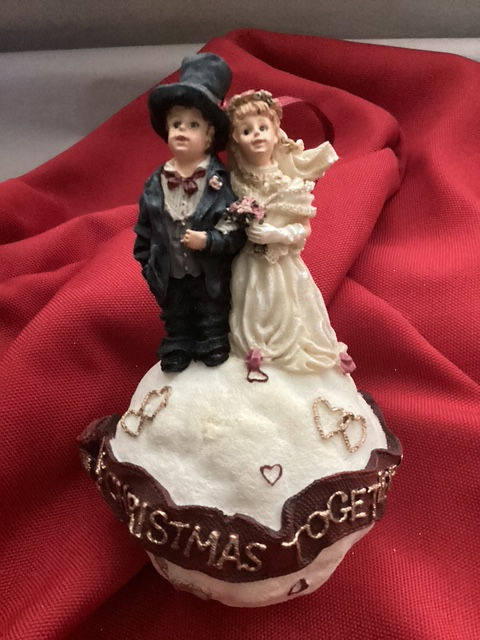 Thumbnail: Description: She is wearing her wedding gown with long formal gloves, while he is wearing a tall top hat with his tuxedo.