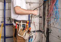 electrician-working-near-board-with-wires-installation-connection-electrics.jpg