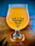 This is either an image of a pint glass filled with the craft beer along with a hand drawn character specific for that brew or, it's the Downhill Brewing logo if there isn't a photo of the brew in a pint glass available.