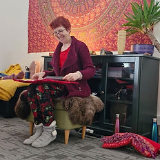 Woman playing music at wellness events in Ireland.