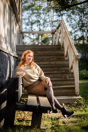 Johanna Huhta is sitting on a bench outside.
