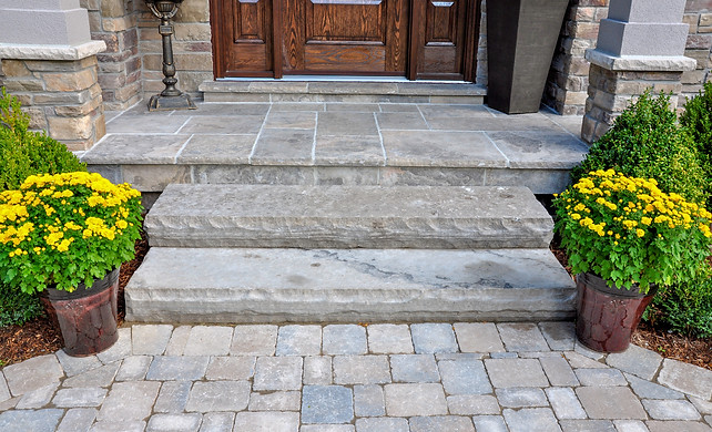 Flagstone applied to the original concrete veranda, natural stone steps, and paver walkway