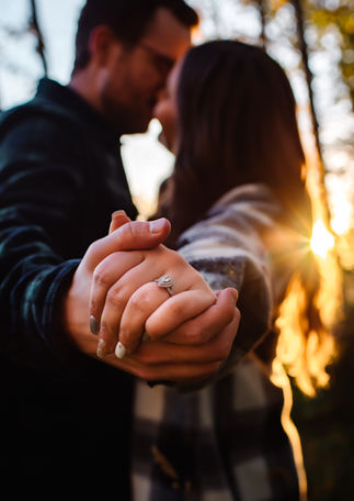 Couple holding hands during a golden hour fall couples session in Red Deer Alberta near Calgary