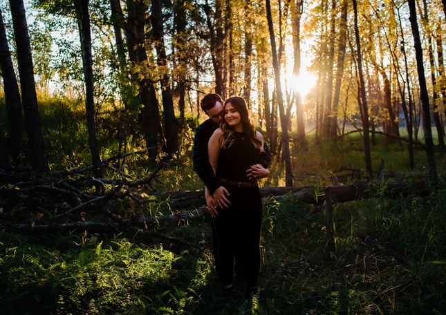 Couple embracing during a golden hour engagement session in Red Deer Alberta near Calgary