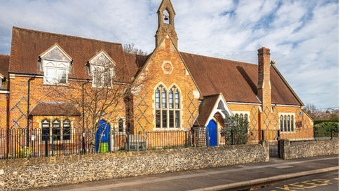 Clement manufactures intricately shaped head steel windows for historic school