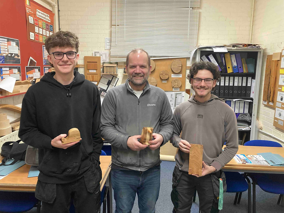 The competition winner, Gordon Reeves (middle) with Daniel Aldridge (right, holding flat phone holder design) and Jaden Ryan-Turner (left, holding whale design)