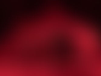 Photographie de scène du spectacle de danse contemporaine "Après la chute" par la compagnie le Théâtre du Corps, montrant un groupe de danseurs en mouvement sous une lumière rouge intense devant un décor de mur en briques.