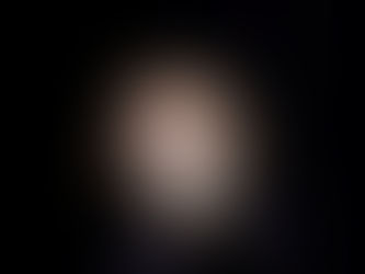 Photographie de scène en clair-obscur montrant le comédien William Mesguich sur fond noir, le visage éclairé par un faisceau de lumière, fixant intensément l'objectif et pointant fermement le doigt vers l'avant.