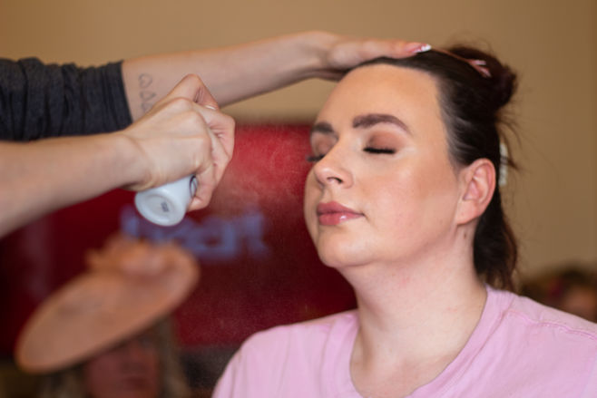Bride getting makeup set with a spray
