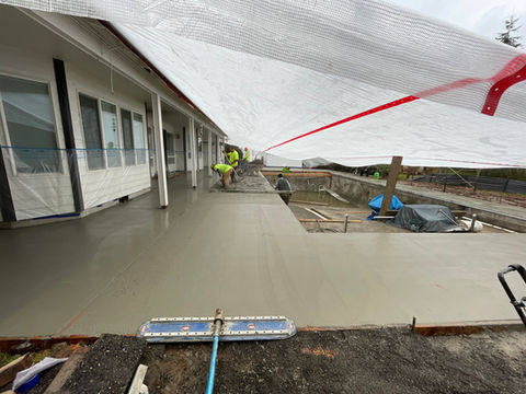 Pouring and smoothing a concrete patio, ensuring a level and long-lasting surface by Tyeco Services