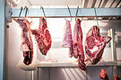 pieces-of-fresh-beef-hanging-in-refrigerator-2026-03-19-10-22-11-utc.jpg