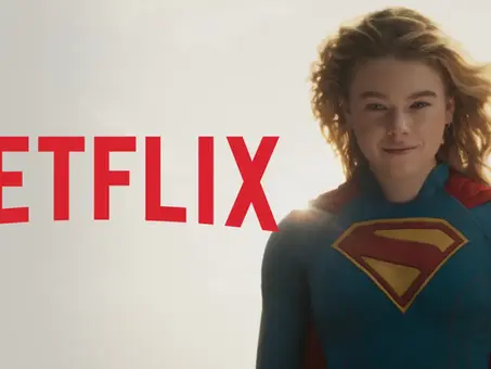 Links ist das rote Netflix-Logo auf hellem Hintergrund zu sehen. Rechts daneben erscheint ein Szenenbild aus dem kommenden Warner-Film „Supergirl“, in dem Milly Alcock als Kara Zor-El alias Supergirl im blauen Superheldenkostüm mit rotem Cape und gelbem „S“-Symbol auf der Brust in die Kamera blickt.