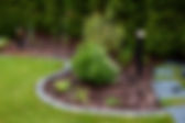 A Beautifully Landscaped Garden That Features Attractive Lights and Decorative Stones.jpg