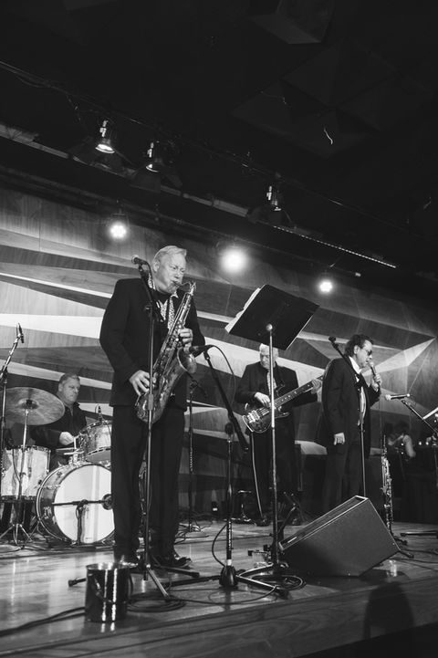 Musician playing instrument on stage.