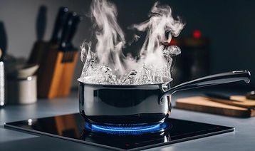 boiling-water-in-a-pot-with-steam-on-modern-stove-in-kitchen-photo.jpeg