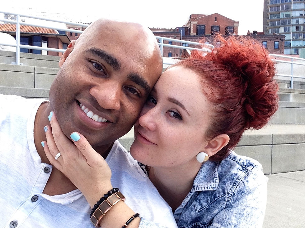 Black man and white woman pose affectionately