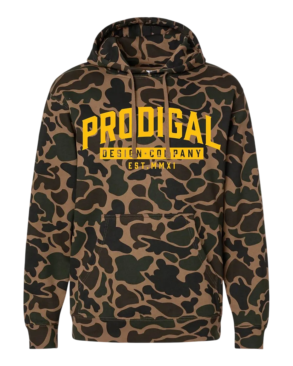 Packshot photography of a hooded sweatshirt featuring a classic brown and green camouflage pattern. Yellow text across the chest reads 'Prodigal Design Company Est. MMXXI'.