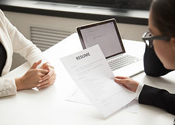 company-representatives-reading-applicant-resume-hiring