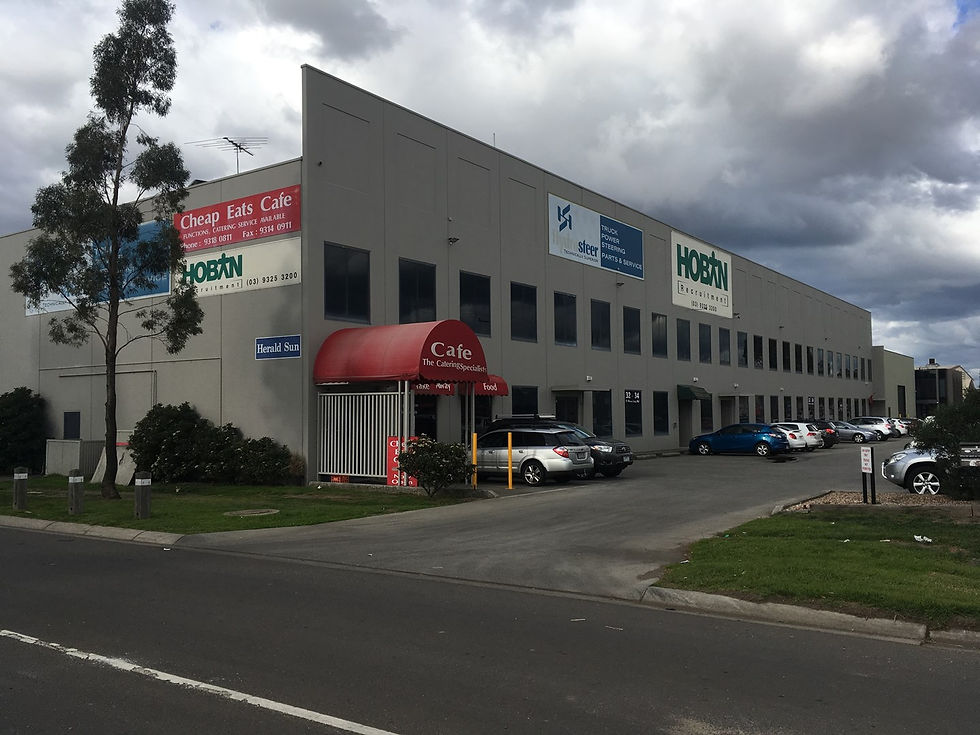 Completed external repaint of a modern multi level corporate office park facade in Mulgrave, showing a clean and uniform finish with high build protective coatings.