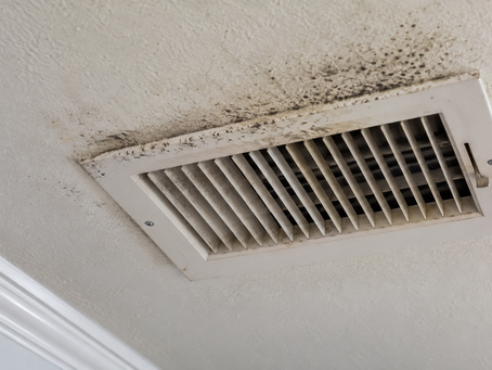 Dark mold-like spots and discoloration around a residential ceiling AC vent, showing possible HVAC moisture and mold concerns in Morganton, North Carolina.