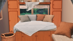 Cozy campervan interior filled with Campervan Living set: a neatly made nap bed with pillows, sheet, and throw blanket, a small sofa with pillows, wooden cupboard, woven wicker shelf and storage boxes, rugs, linen curtains, hanging blanket, pampas grass bouquet, string of pearls plant, and raffia hat, creating a warm and lived-in tiny van space.