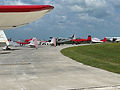 Row of six small planes parked on the G A ramp at Fort Dodge Regional Airport.