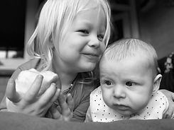 Toddler eating Apple with baby.JPG