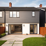dark grey composite cladding on top half of house, bottom half painted white, recently installed near gravesend