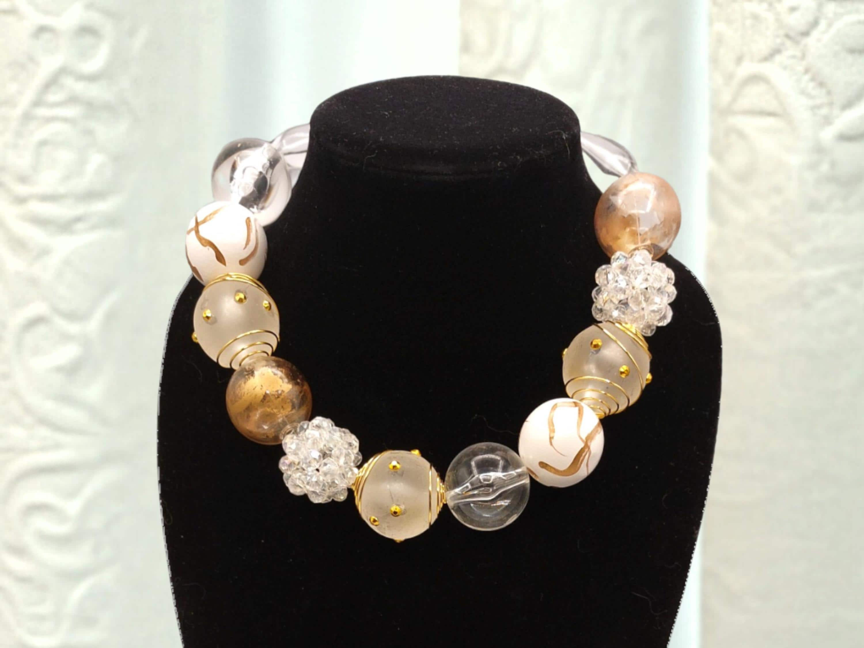 Necklace with large amber beads on display, elegant fashion accessory.