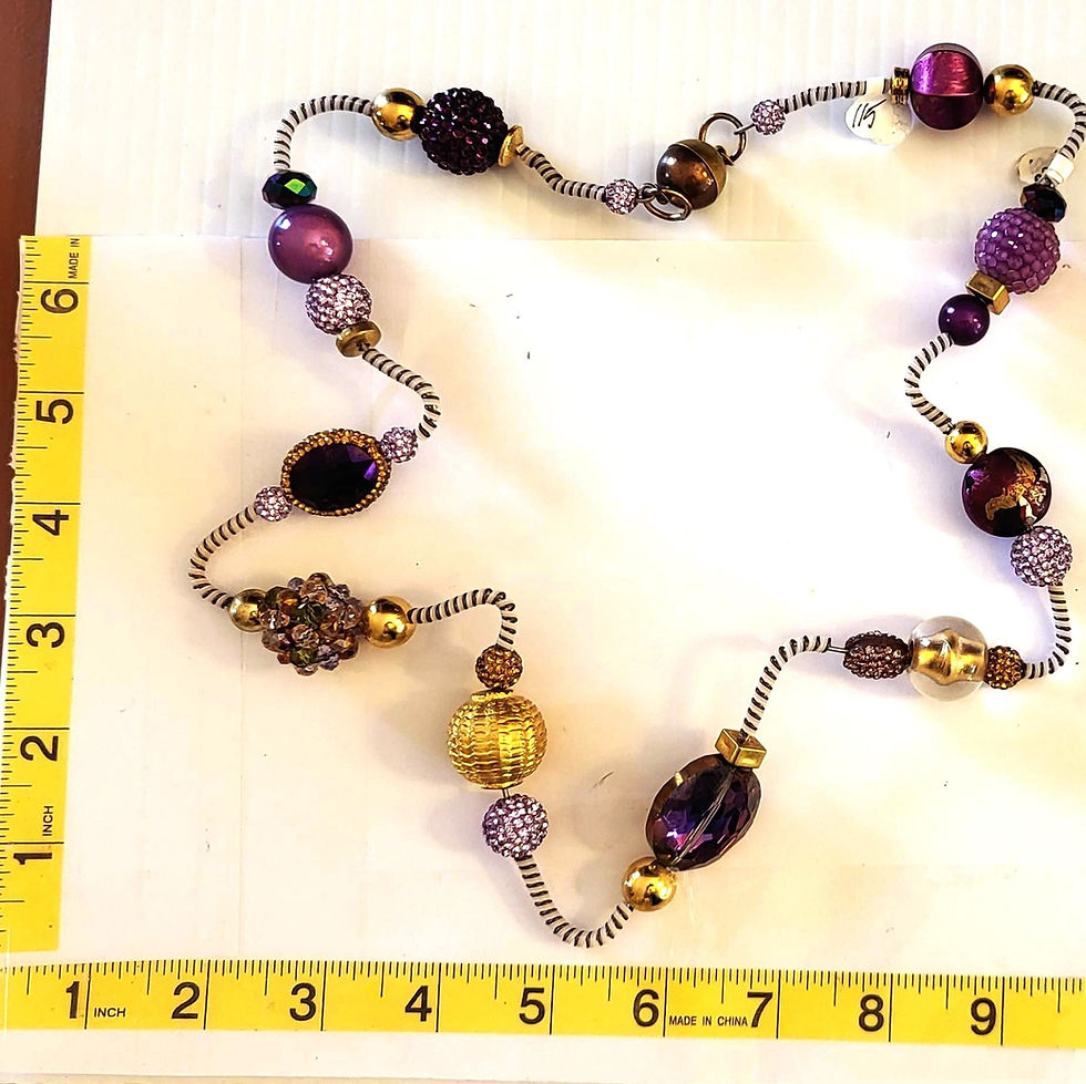 Thumbnail: Purple beaded necklace on measuring tape; Gold and Pearl Statement Necklace.