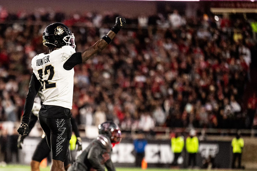 Travis Hunter holds his fist in the air