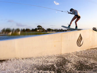 Woman wakeboarding, sliding on rooftop