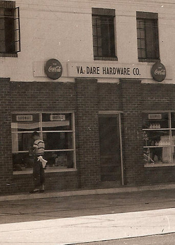 Vintage photo of the YK Dare Hardware Co. storefront with a man standing outside the Historic Location